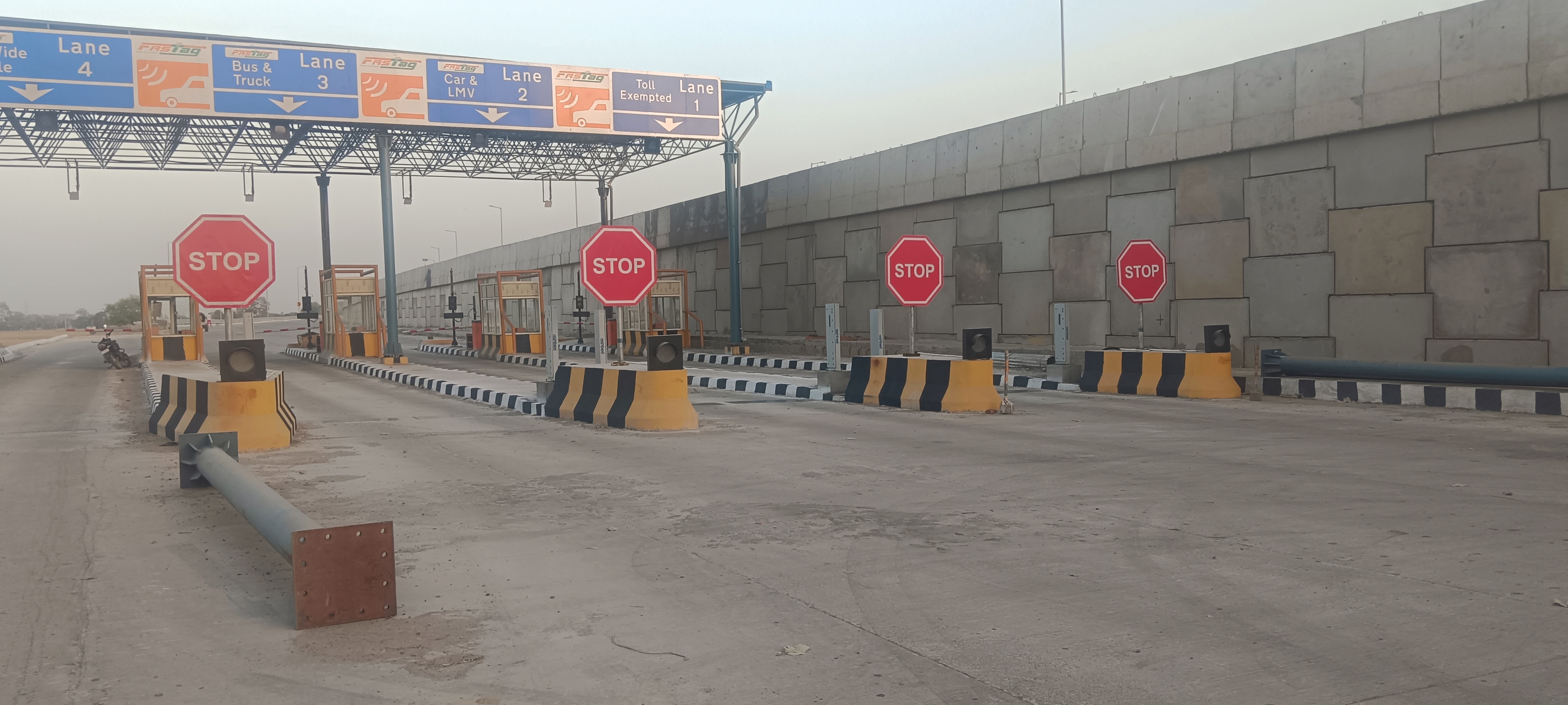 Freshly painted toll plaza with road markings and infrastructure maintenance work completed by our team.